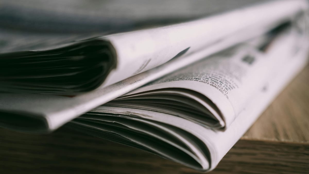 Close-up of Newspapers on Wooden Table