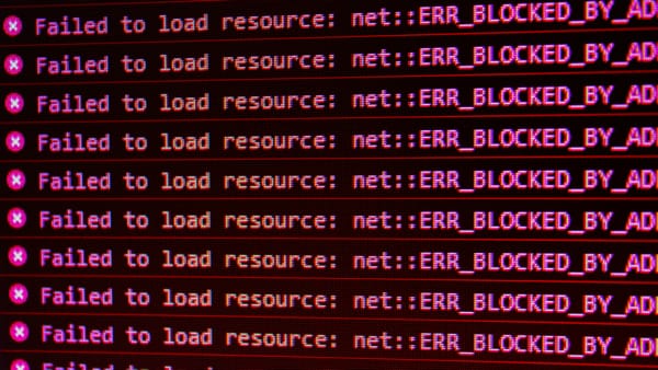A computer screen showing the error "X Failed to load resource: net :: ERR_BLOCKED_BY_AD" repeatedly