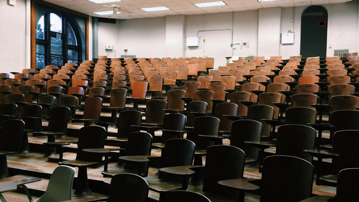 A series of empty seats in a lecture hall