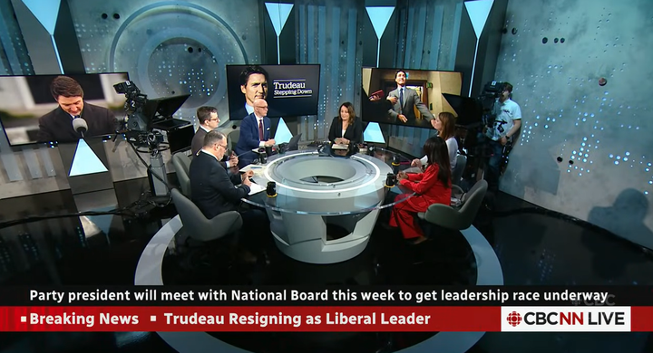 CBC Panel discussing around the table. Multiple panelists are present while Rosemary Barton and David Cochrane are visible.